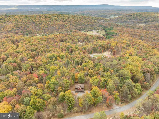 a backyard of a house with wooden floor and outdoor seating