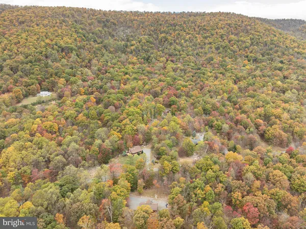 a spacious bedroom with a large bed and a chandelier