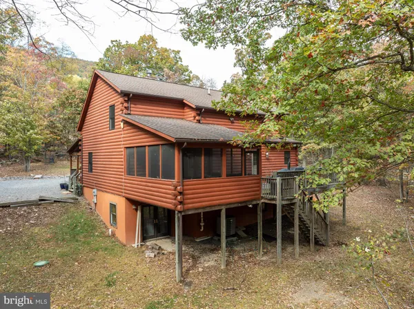 a living room with patio furniture and a rug