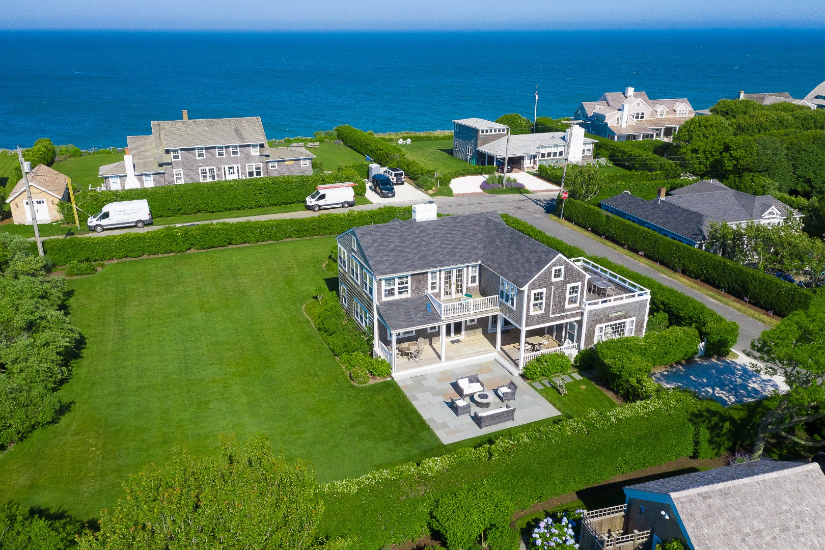 76 Baxter Road Nantucket, MA 02554 - Photo 2 of 25 an aerial view of a house with a garden potted plants and large trees