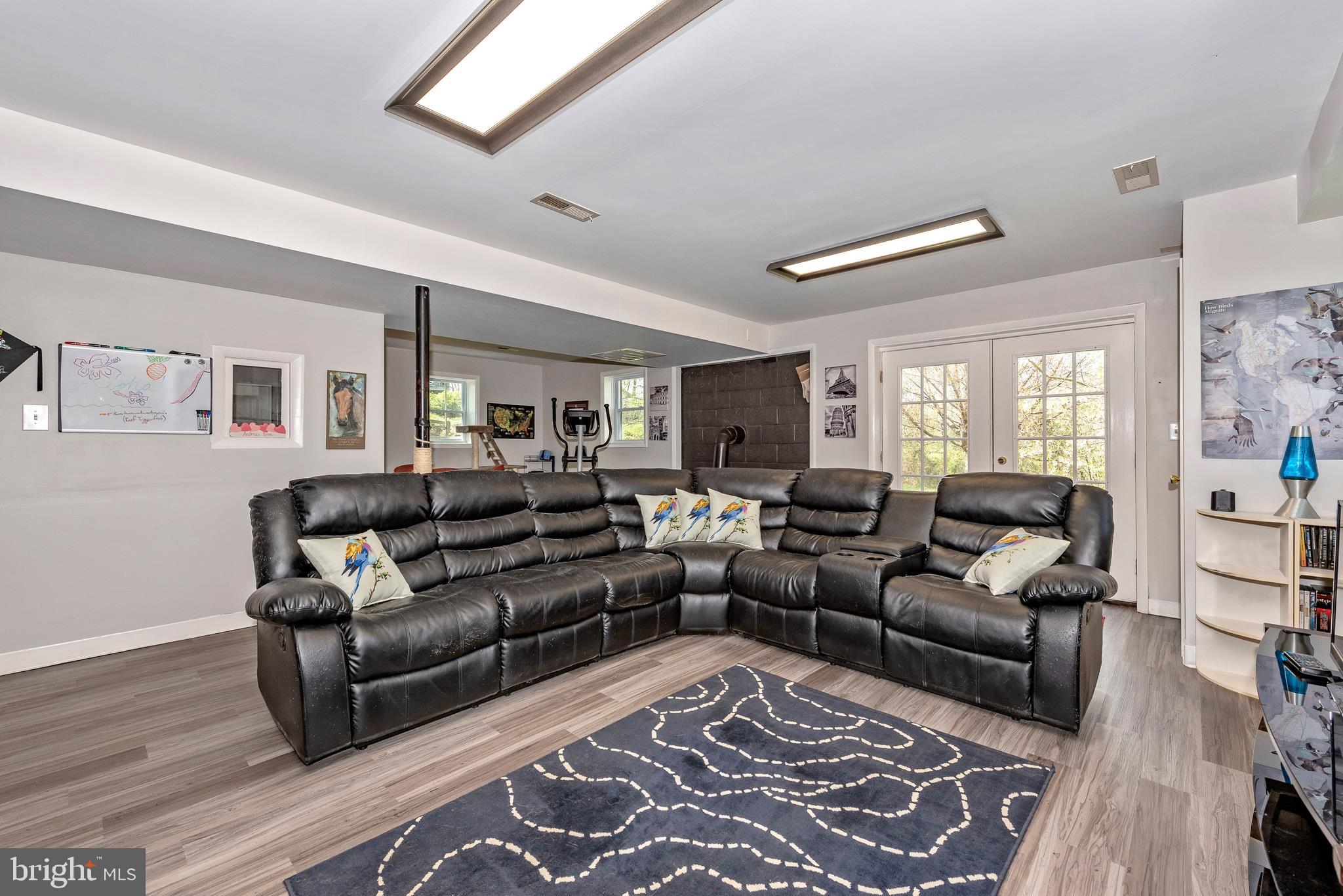 27455 Clarksburg Road Damascus, MD 20872 - Photo 24 of 57 lower level family room with wood stove