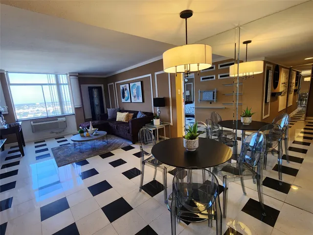 a room with furniture a rug and a chandelier