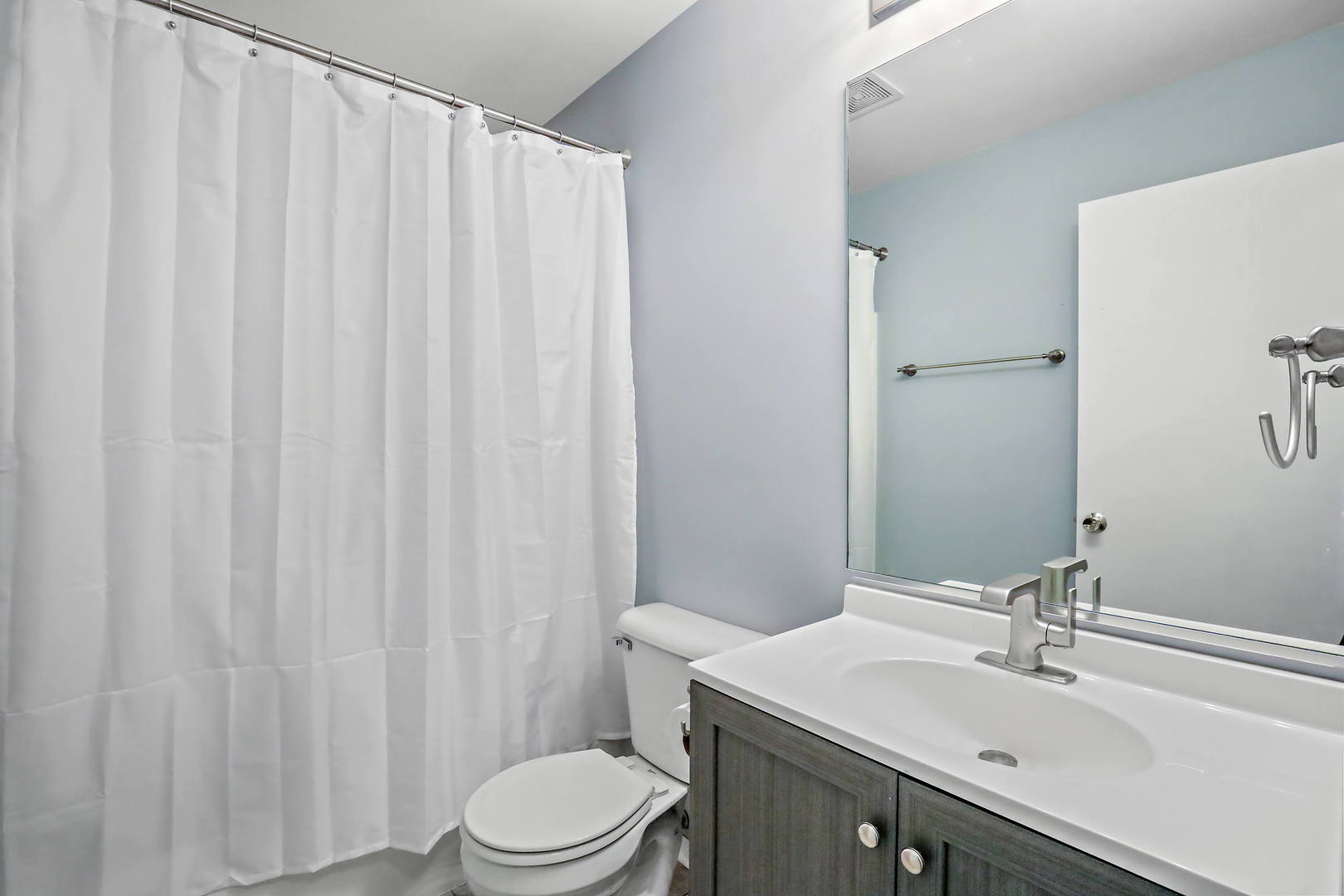 25294 Faraday Road Manhattan, IL 60442 - Photo 16 of 16 a bathroom with a sink a toilet and shower curtain