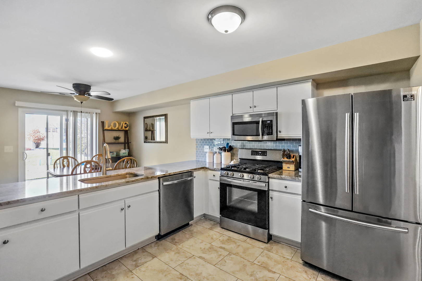 25294 Faraday Road Manhattan, IL 60442 - Photo 7 of 16 a kitchen with stainless steel appliances granite countertop a refrigerator sink and stove