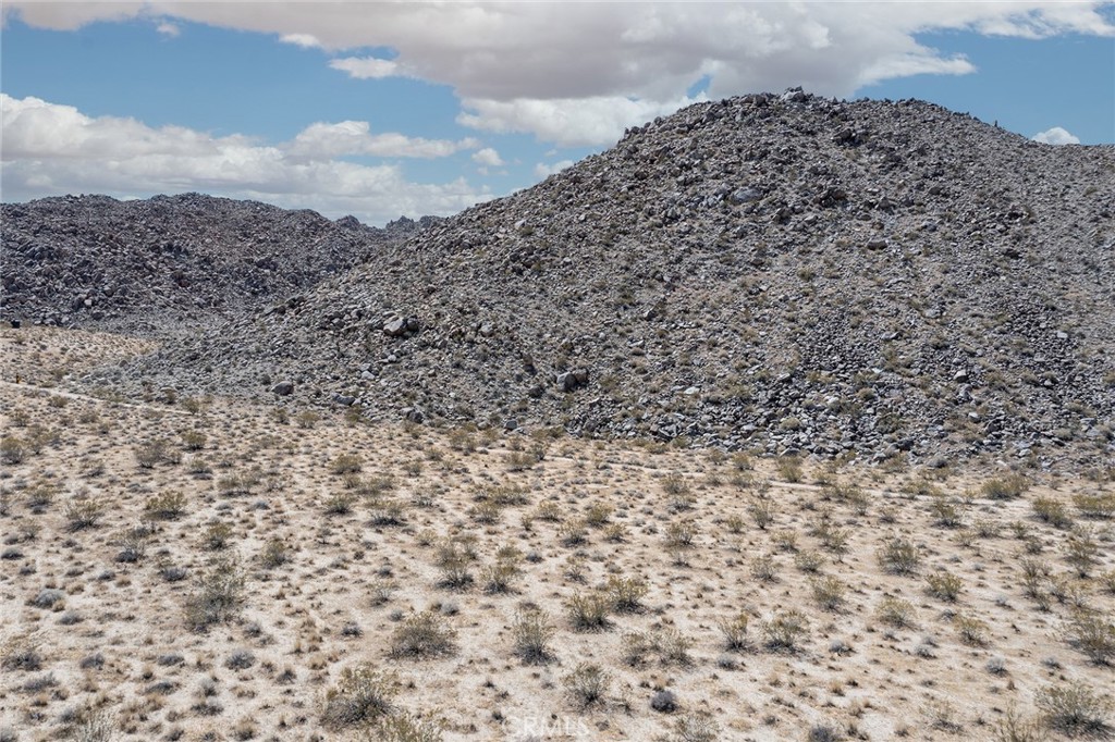 62600 Sullivan Road Joshua Tree, CA 92252 - Photo 14 of 15 a large stone wall with a building in the background