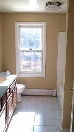 7 Kittredge Road Spencer, MA 01562 - Photo 8 of 16 a bathroom with a granite countertop toilet a sink and a window
