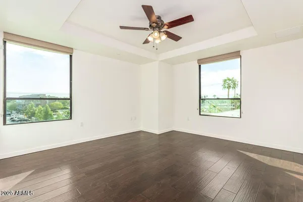 a view of a room with a window and a ceiling fan