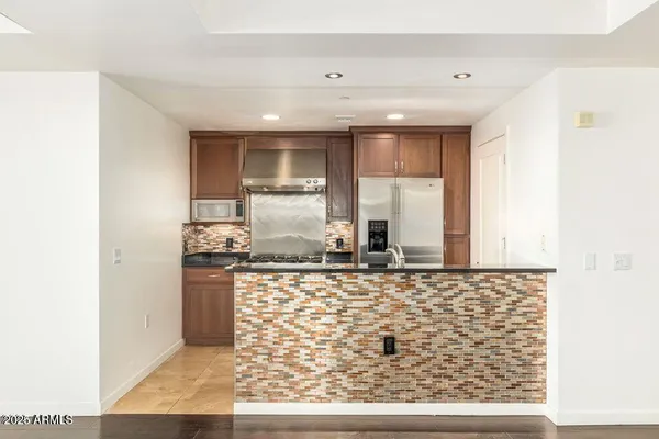 a kitchen with stainless steel appliances granite countertop a sink stove and cabinets