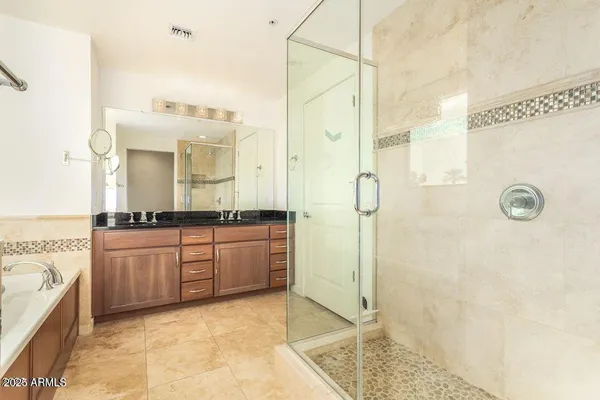 a bathroom with a granite countertop sink mirror and shower