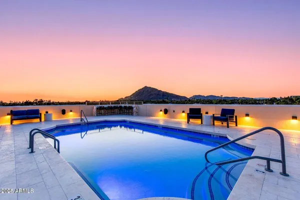 a large kitchen with stainless steel appliances and wooden cabinets