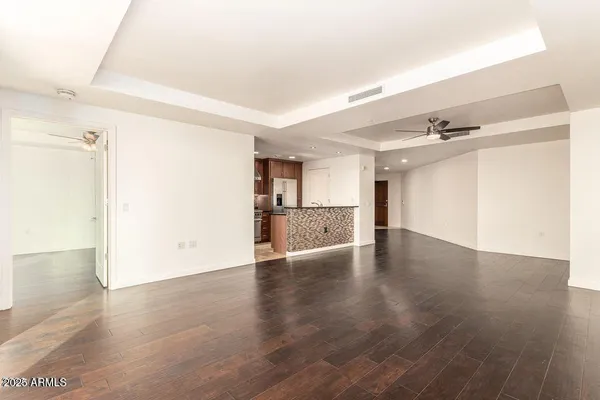 a view of a kitchen with a sink and wooden floor