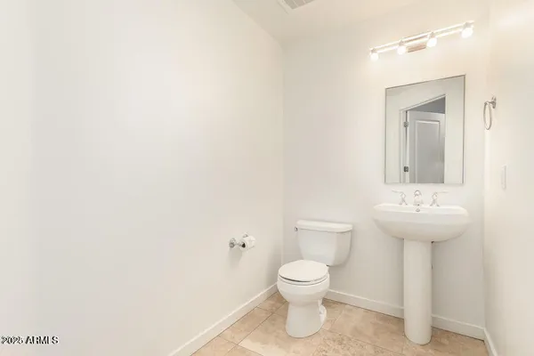 a bathroom with a sink a toilet and mirror