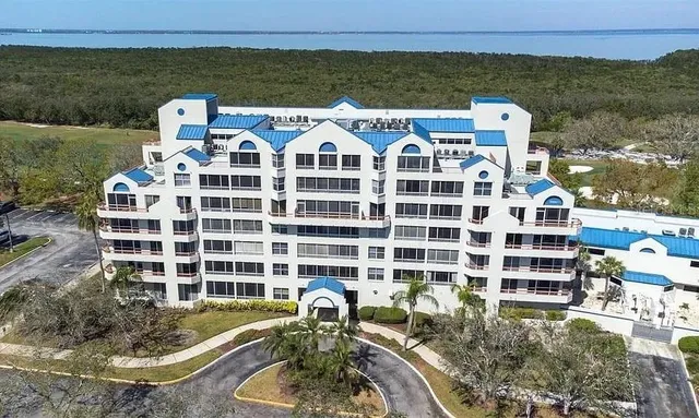 a view of a building with a yard and sitting area