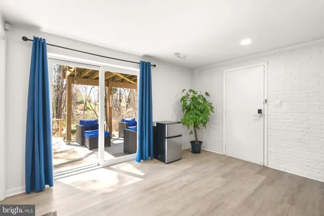 a view of a room with wooden floor and a potted plant