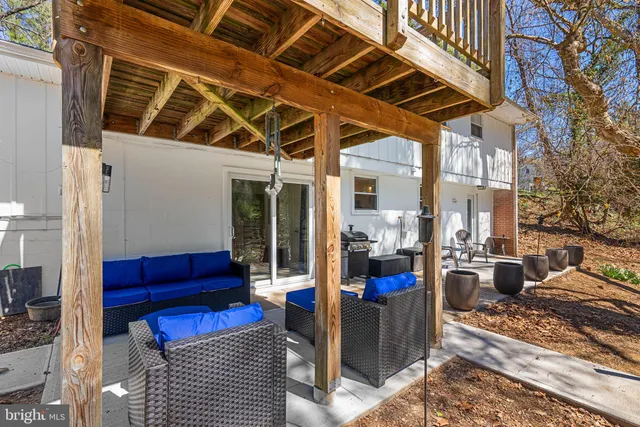 a view of a patio with couches chairs and a potted plant