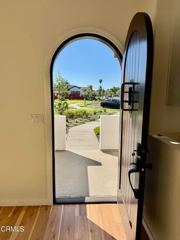 a view of a kitchen with wooden floor and stainless steel appliances