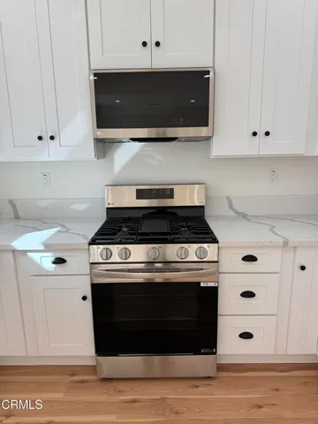 a view of kitchen with microwave and window