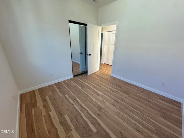 a view of a room with wooden floor