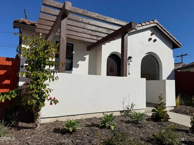 a view of a house with potted plants
