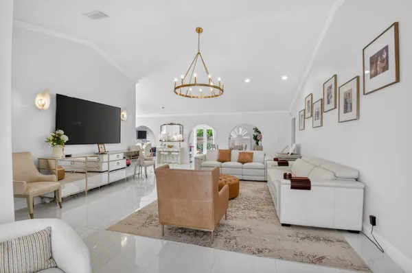 a living room with couches and a flat screen tv
