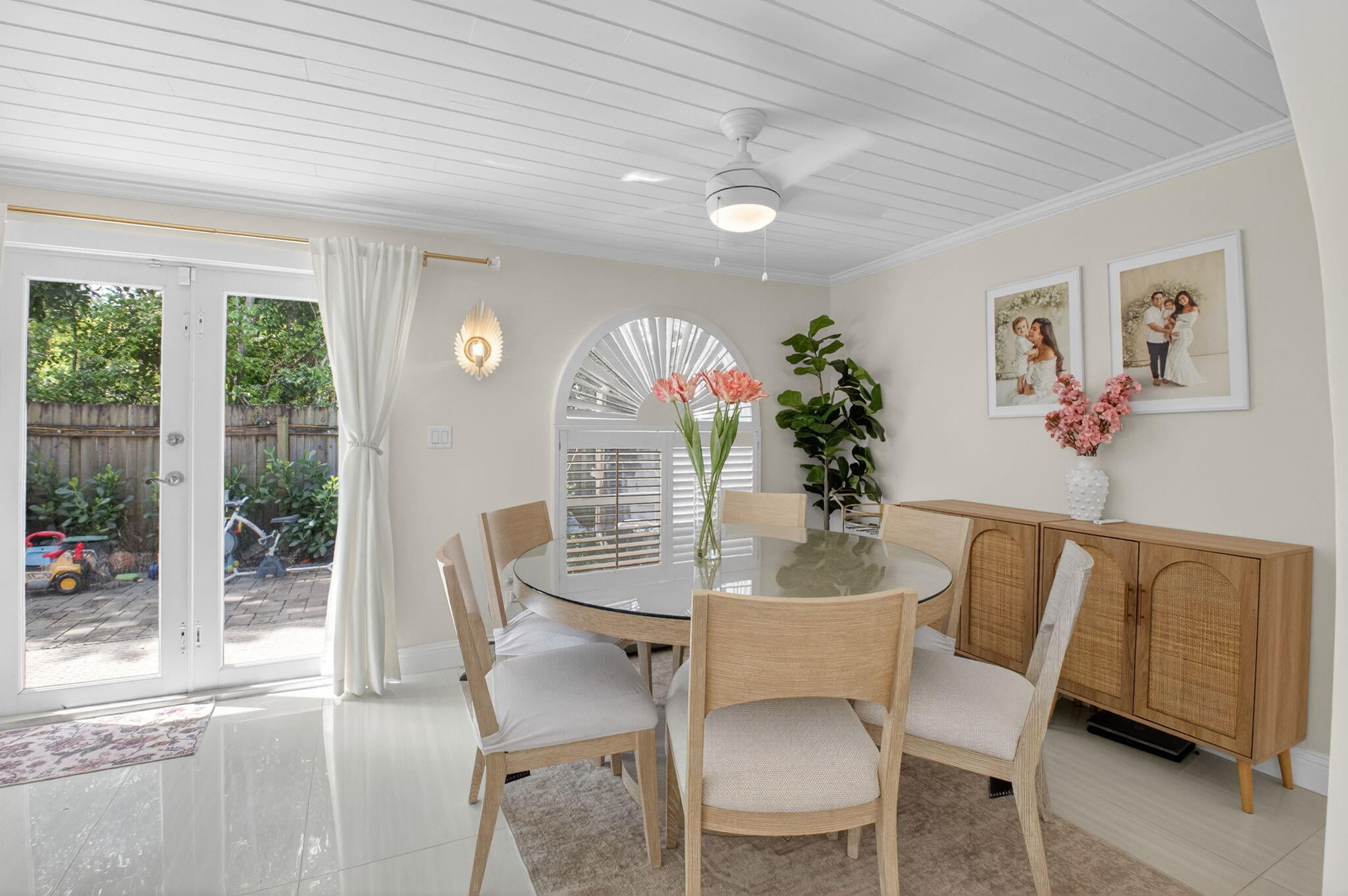 2402 Northwest 30th Street Boca Raton, FL 33431 - Photo 14 of 45 a dining room with furniture potted plants and wooden floor