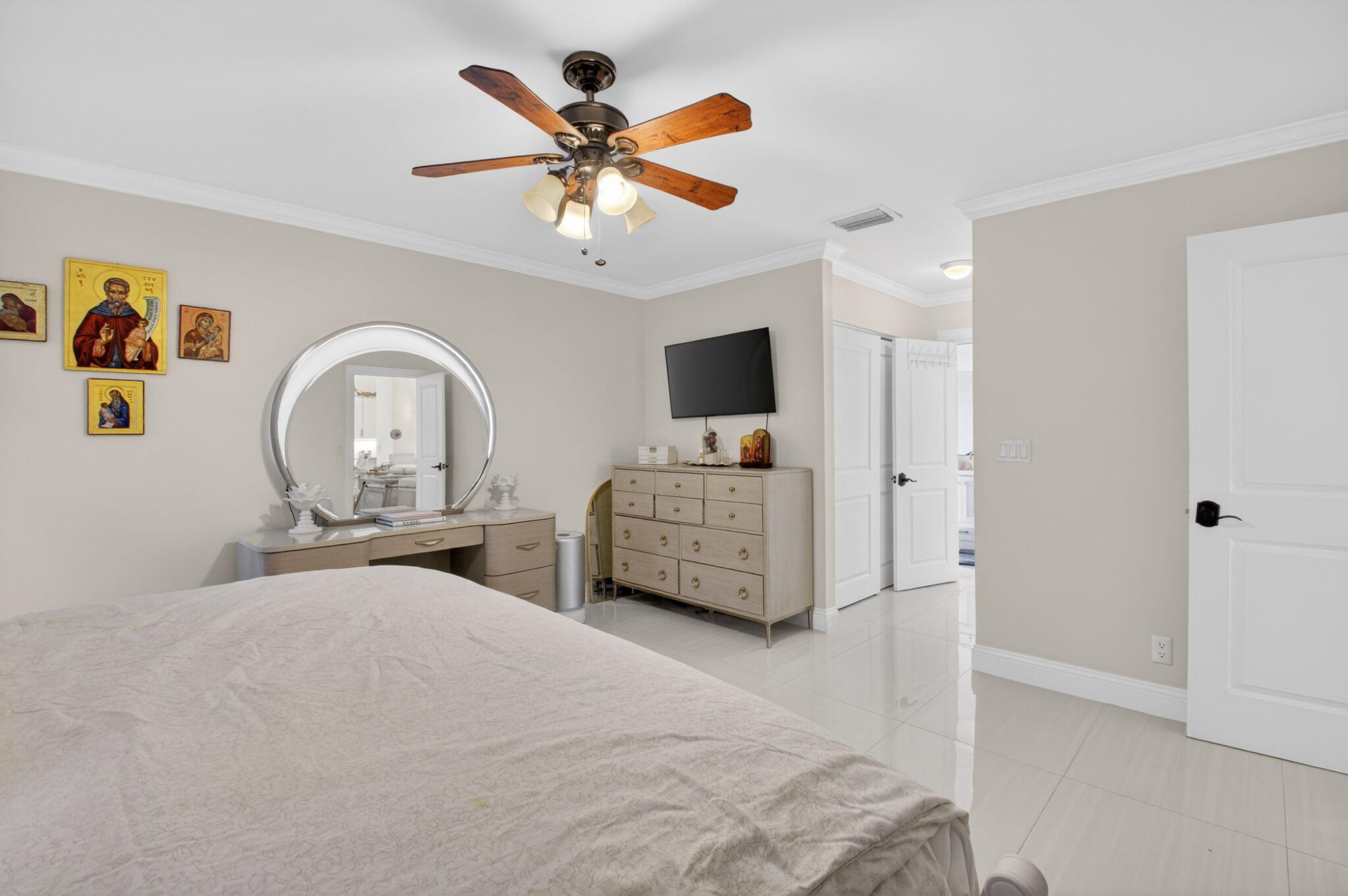 2402 Northwest 30th Street Boca Raton, FL 33431 - Photo 20 of 45 a bedroom with a bed and a chandelier