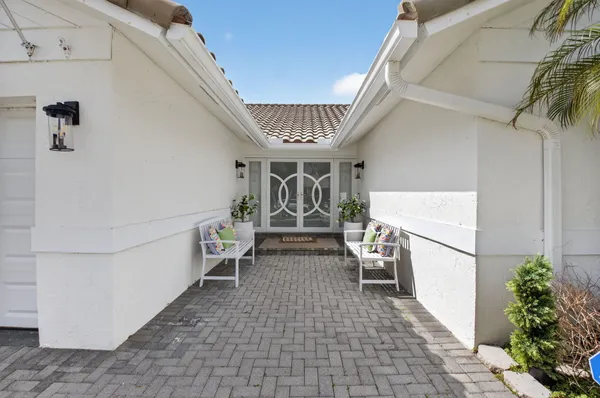 a view of a house with a yard and sitting area