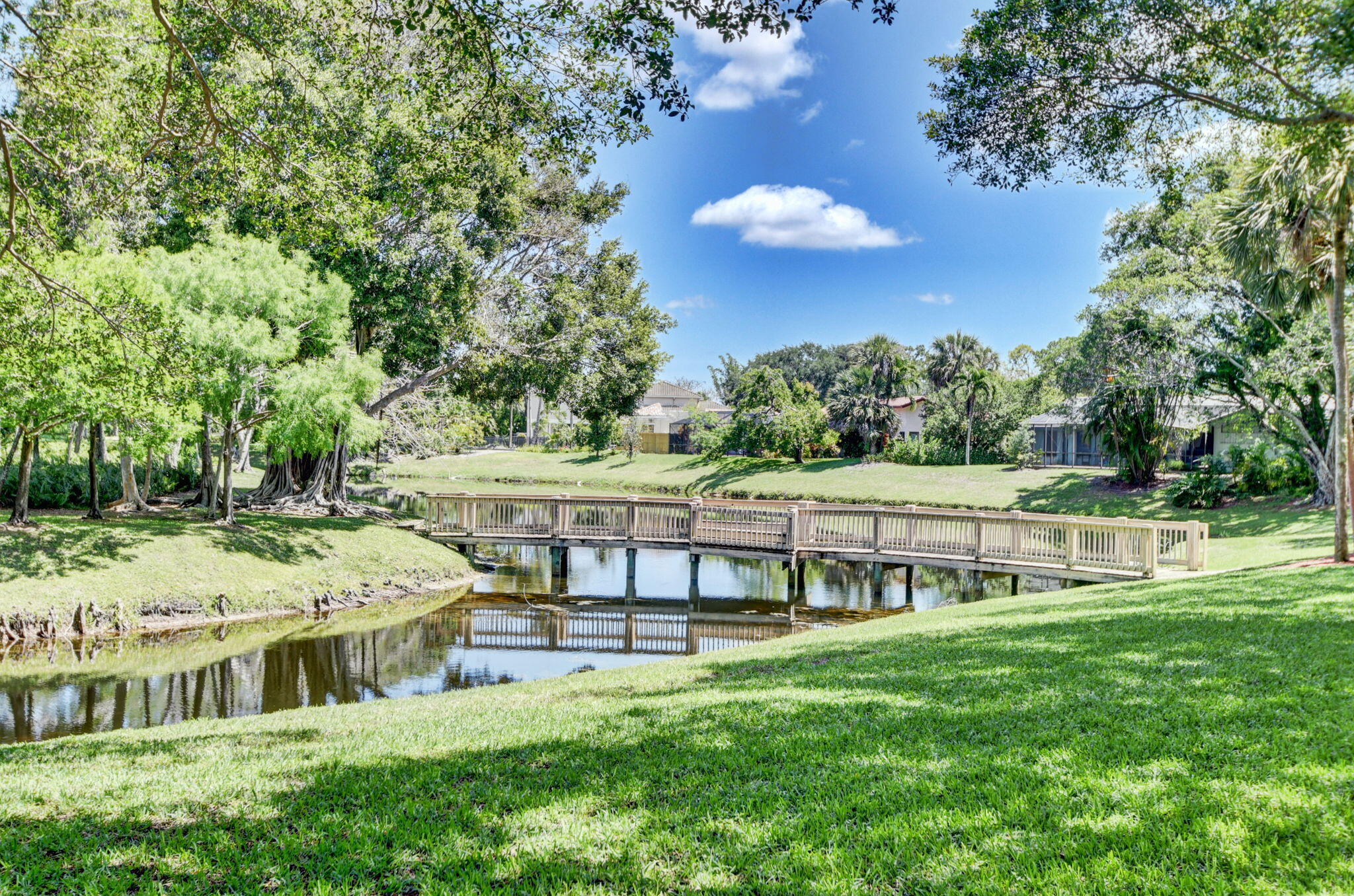 2402 Northwest 30th Street Boca Raton, FL 33431 - Photo 44 of 45 a view of a house with a big yard and large trees