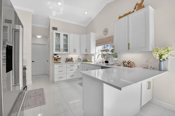 a view of kitchen with center island and stainless steel appliances