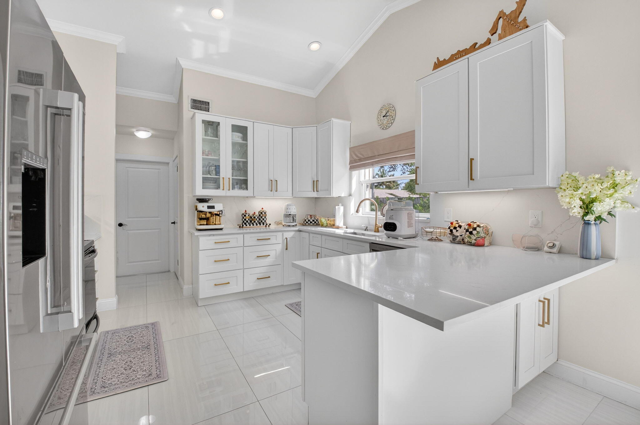 2402 Northwest 30th Street Boca Raton, FL 33431 - Photo 9 of 45 a view of kitchen with center island and stainless steel appliances