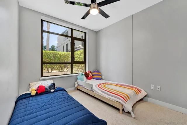 a bedroom with bed and a window