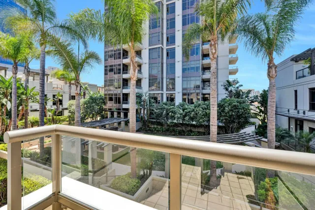 a view of a balcony with palm trees