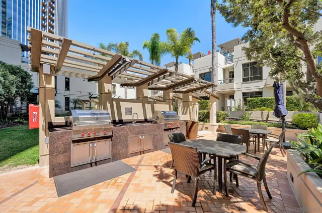 a view of a patio with table and chairs potted plants and palm tree