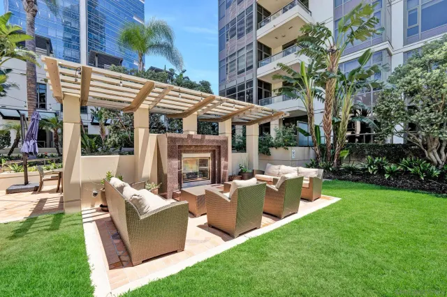 a view of a patio with couches table and chairs and potted plants