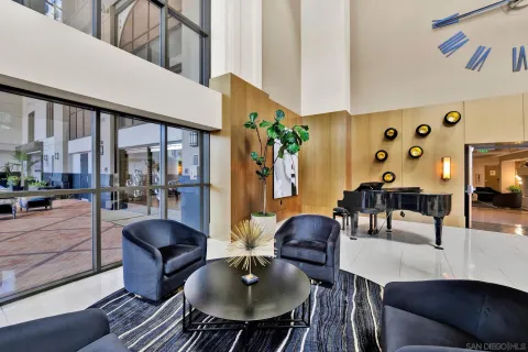 a living room with furniture and a floor to ceiling window