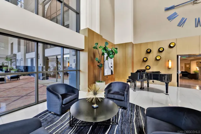 a living room with furniture and a floor to ceiling window