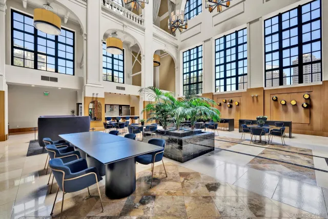 a living room with fireplace furniture and a potted plant