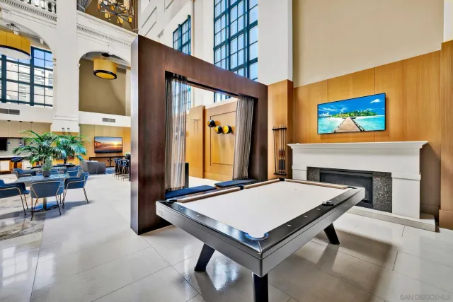 a living room with furniture a fireplace and a potted plant