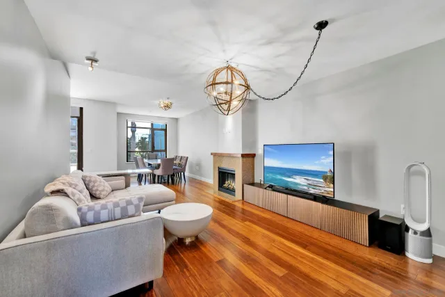 a living room with furniture a fireplace and a flat screen tv
