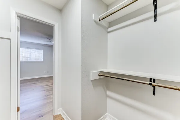 a view of a room with wooden floor