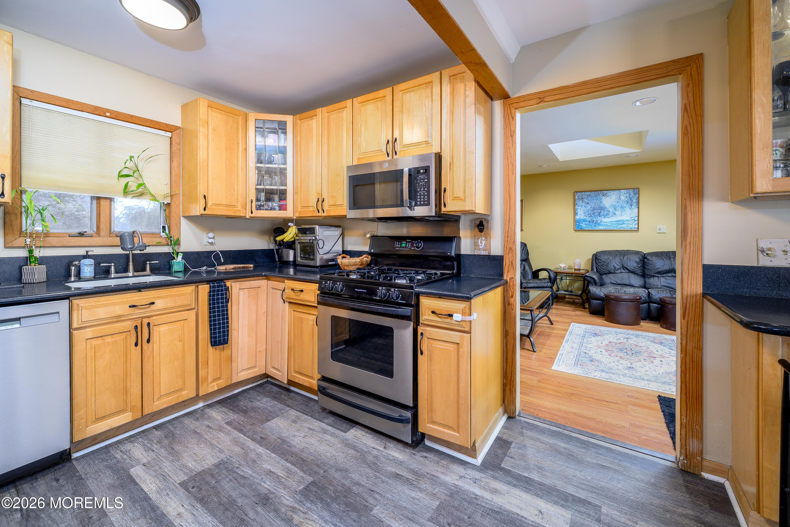 351 Taylors Mills Road Manalapan, NJ 07726 - Photo 3 of 29 a kitchen with stainless steel appliances granite countertop a stove a sink and a microwave