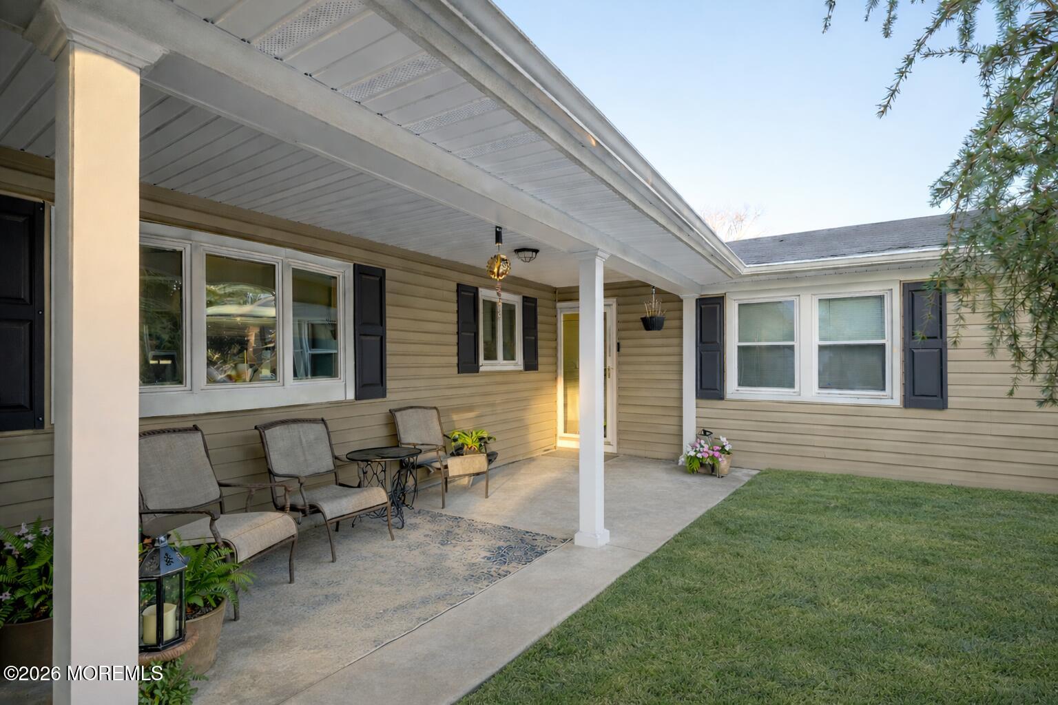 351 Taylors Mills Road Manalapan, NJ 07726 - Photo 6 of 29 a front view of a house with outdoor seating