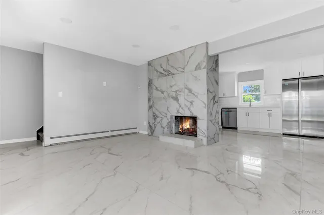 a view of empty room with fireplace