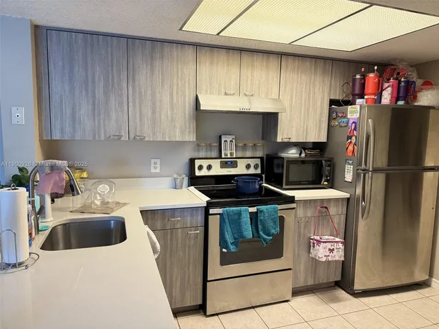 a kitchen with a stove sink and refrigerator