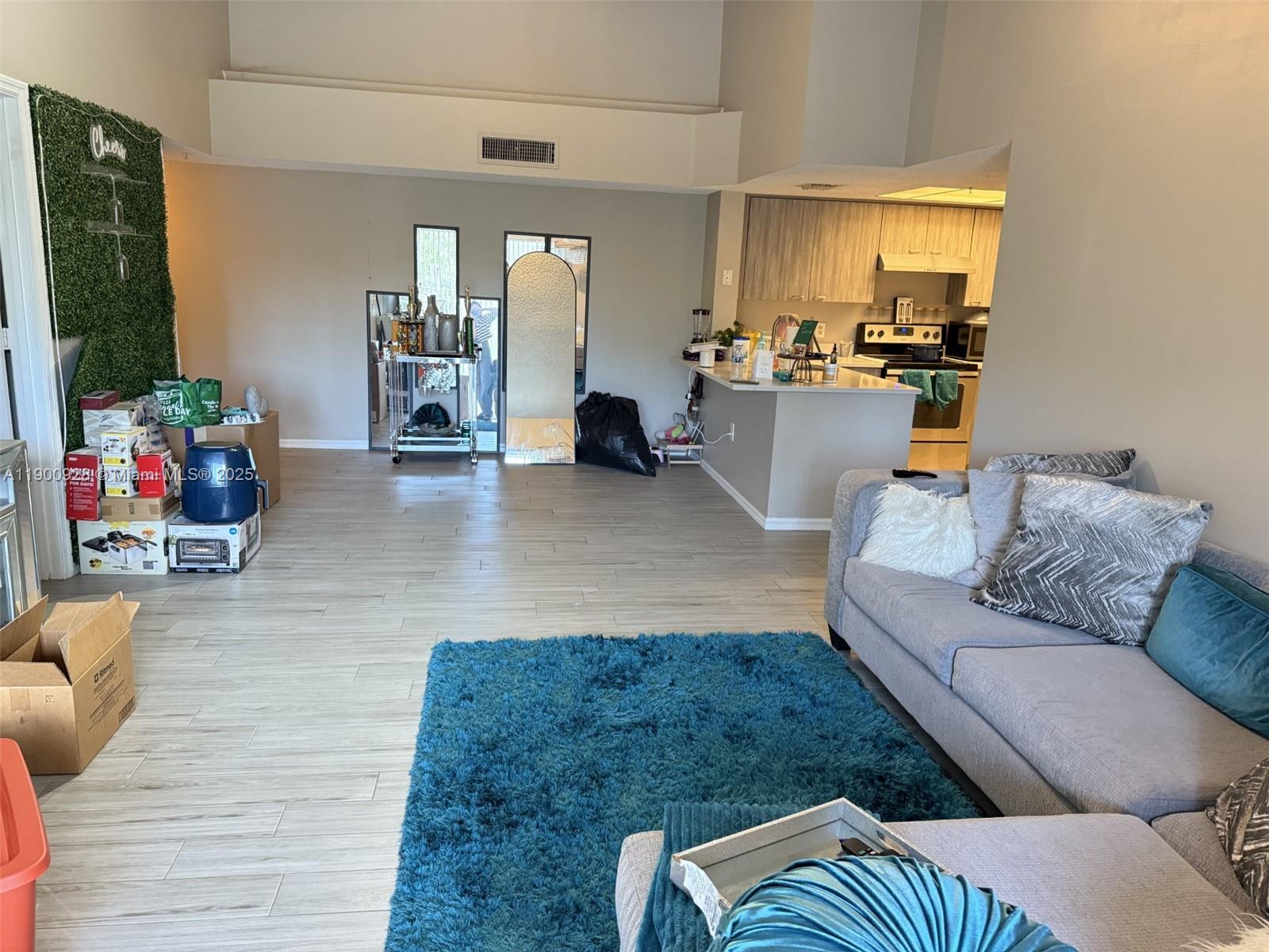 5015 Wiles Road, Unit 207 Coconut Creek, FL 33073 - Photo 7 of 11 a living room with furniture and a flat screen tv