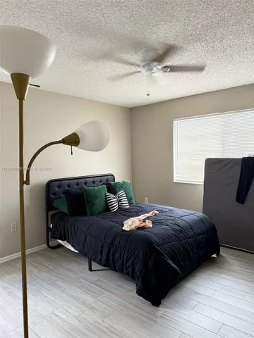 a bedroom with a bed window and a mirror