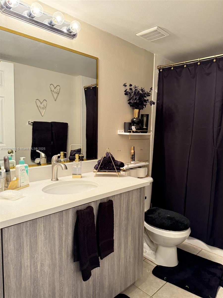 5015 Wiles Road, Unit 207 Coconut Creek, FL 33073 - Photo 9 of 11 a bathroom with a sink and a mirror