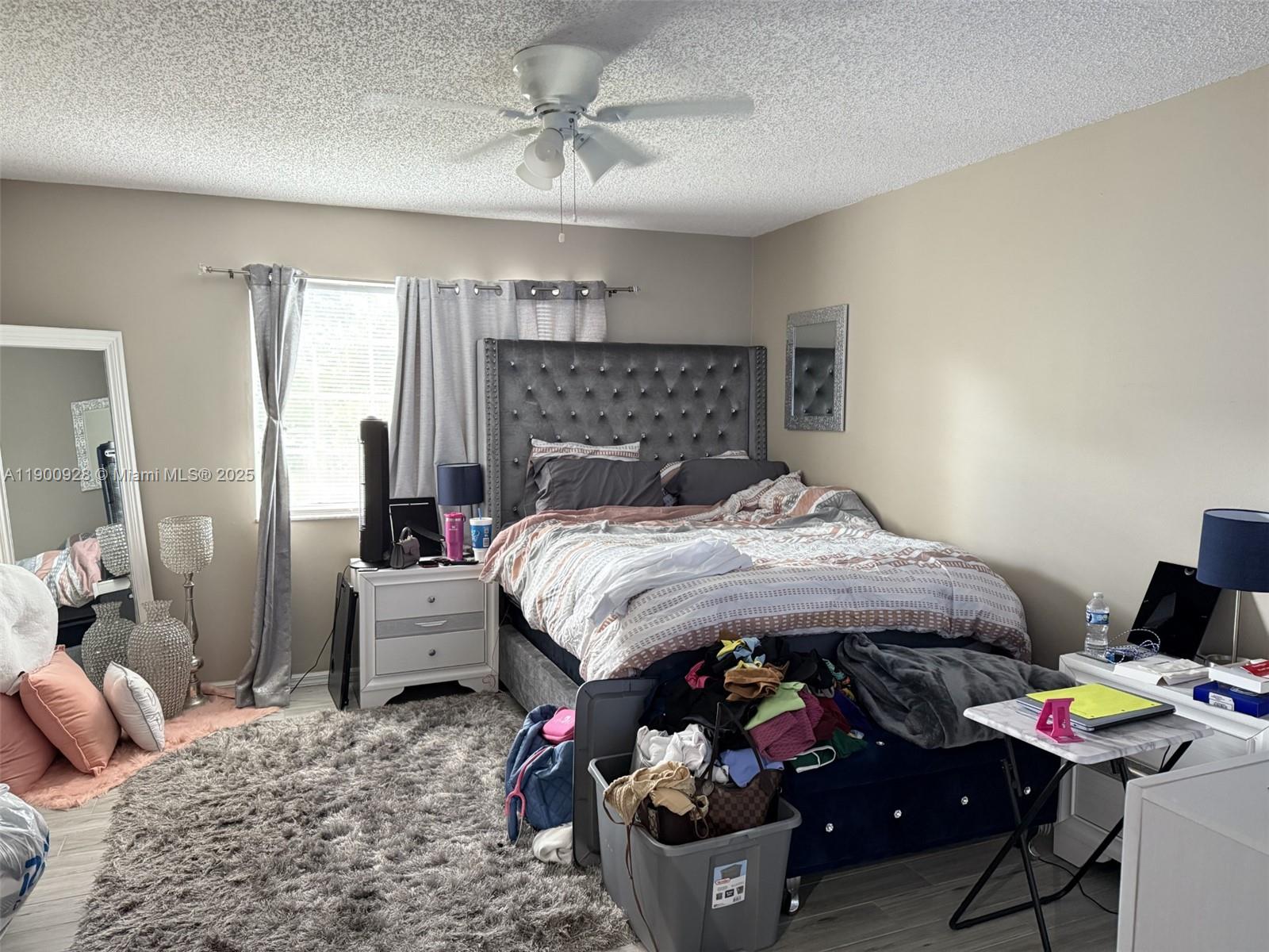 5015 Wiles Road, Unit 207 Coconut Creek, FL 33073 - Photo 10 of 11 a bedroom with a bed and a window