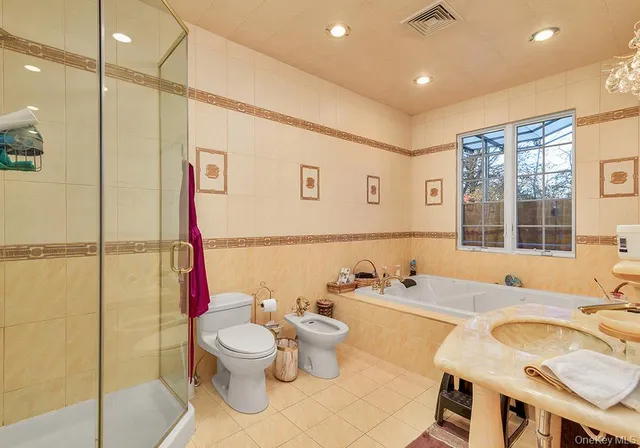 a bathroom with a granite countertop sink a toilet and a shower