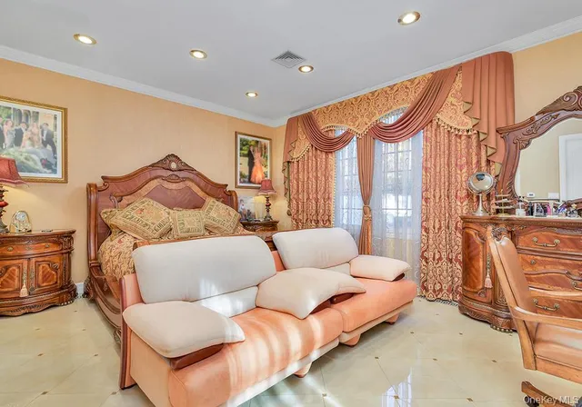 a spacious bedroom with a bed and a couch